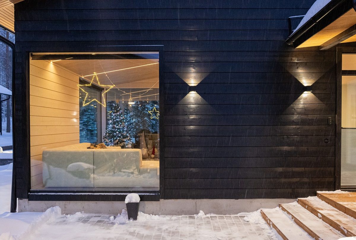 On an exterior wall, a black Funk wall light adds a beautiful photographic effect and the light itself blends in with the wall tone